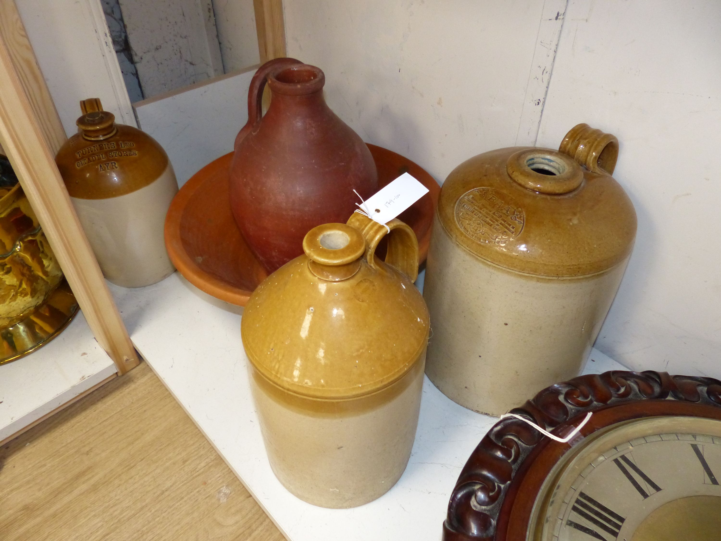 Stoneware flagons and a terracotta dairy bowl